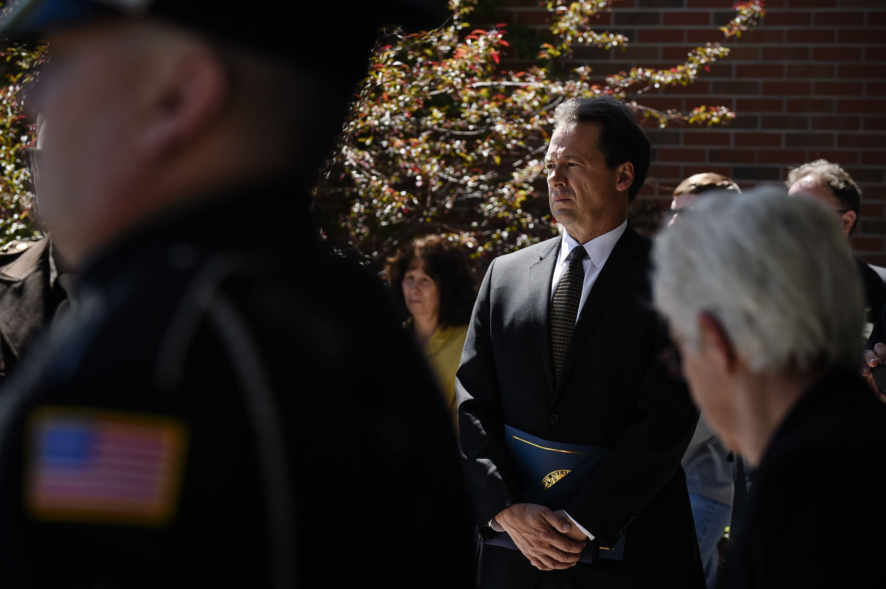 Gov. Steve Bullock watches as pallbearers carry the casket of deputy Mason Moore into Three Forks High School Tuesday afternoon.